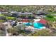 Aerial view of the community pool featuring lounge seating, shade, and mature landscaping at 12439 W Yellow Bird Ln, Peoria, AZ 85383