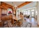 Bright dining room with chandelier, custom paint, and wood table for six, and an open concept into the living room at 12439 W Yellow Bird Ln, Peoria, AZ 85383
