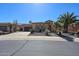 Inviting home exterior with desert landscaping, including palm trees, and a paved driveway at 12439 W Yellow Bird Ln, Peoria, AZ 85383