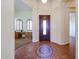 Foyer with tile flooring, decorative mosaic inlay, and access to a study and hallway at 12439 W Yellow Bird Ln, Peoria, AZ 85383