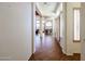 Hallway with tile flooring leading to the dining room and bedrooms with shuttered windows at 12439 W Yellow Bird Ln, Peoria, AZ 85383
