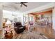 Open concept living room and dining room featuring tile floors, ceiling fan, and fireplace for a cozy, bright space at 12439 W Yellow Bird Ln, Peoria, AZ 85383