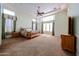 Spacious main bedroom with trey ceiling, ceiling fan, carpet flooring, and plenty of natural light at 12439 W Yellow Bird Ln, Peoria, AZ 85383