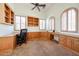 Spacious office with custom built-in cabinetry, neutral carpet, and multiple windows at 12439 W Yellow Bird Ln, Peoria, AZ 85383