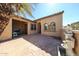 Covered patio with a cozy fireplace, brick pavers, and an outdoor water feature at 12439 W Yellow Bird Ln, Peoria, AZ 85383