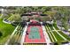 Aerial view of tennis courts with tennis being played amid mature landscaping at 12439 W Yellow Bird Ln, Peoria, AZ 85383