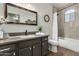 Bathroom with a single sink vanity, modern fixtures and a shower-tub combo at 12749 W Sheridan St, Avondale, AZ 85392