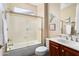 Traditional bathroom featuring vanity, toilet, and bathtub with clear glass door at 13065 W Lucia Dr, Peoria, AZ 85383