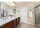 Well-lit bathroom features a double vanity, ample counter space, and glass enclosed shower at 13065 W Lucia Dr, Peoria, AZ 85383