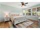 Serene bedroom showcases a plush bed, stylish nightstands, and abundant natural light through shuttered windows at 13065 W Lucia Dr, Peoria, AZ 85383