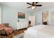 Comfortable bedroom features a serene color palette, dresser, and cozy seating area near bathroom entrance at 13065 W Lucia Dr, Peoria, AZ 85383