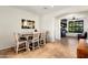 Dining room features a modern table set, decorative mirror, and flows into adjoining living spaces at 13065 W Lucia Dr, Peoria, AZ 85383