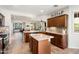 Open kitchen featuring an island, wooden cabinets, stainless appliances, and seamless flow to living area at 13065 W Lucia Dr, Peoria, AZ 85383