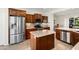 Spacious kitchen featuring stainless steel appliances, a central island, and abundant wooden cabinetry at 13065 W Lucia Dr, Peoria, AZ 85383