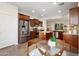 Bright kitchen boasts stainless steel appliances, wood cabinets, and a glass table for casual dining at 13065 W Lucia Dr, Peoria, AZ 85383
