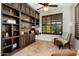 Cozy office showcases custom built-in shelving, a window with shutters, and comfortable seating at 13065 W Lucia Dr, Peoria, AZ 85383