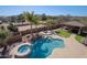 Aerial view showcases the pool, spa, outdoor kitchen, and lush landscaping of the estate at 13627 E Monument Dr, Scottsdale, AZ 85262
