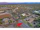 Wide aerial shot showing a house in a desert community, highlighting the surrounding landscape at 13627 E Monument Dr, Scottsdale, AZ 85262