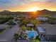 Backyard oasis with pool, spa, fire pit, and outdoor kitchen under a covered pavilion at 13627 E Monument Dr, Scottsdale, AZ 85262