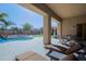 The backyard includes a covered patio with seating, outdoor kitchen, pool, and mature landscaping at 13627 E Monument Dr, Scottsdale, AZ 85262