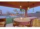 Outdoor kitchen featuring bar seating, a grill, and firepit next to the pool and lounge chairs for entertaining at 13627 E Monument Dr, Scottsdale, AZ 85262