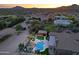 Aerial view of outdoor living space, highlighting the pool, jacuzzi, and desert landscaping at 13627 E Monument Dr, Scottsdale, AZ 85262