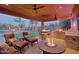 Lounge in a backyard complete with an outdoor kitchen, fire pit, a pool, and palm trees to enhance outdoor living at 13627 E Monument Dr, Scottsdale, AZ 85262