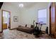 Bonus room with wood-look tile, a sofa, exercise equipment, and natural light at 13627 E Monument Dr, Scottsdale, AZ 85262