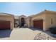 Charming home exterior with a three-car garage and mature desert landscaping at 13627 E Monument Dr, Scottsdale, AZ 85262