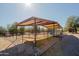 Outdoor horse shelter with metal roof and fencing at 13627 E Monument Dr, Scottsdale, AZ 85262