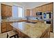 Gourmet kitchen with granite counters, cooktop island and stainless appliances at 13627 E Monument Dr, Scottsdale, AZ 85262