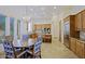 Open kitchen and dining area with travertine tile floors and large windows at 13627 E Monument Dr, Scottsdale, AZ 85262