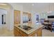 Open-concept kitchen with cooktop island, stainless fridge, and pantry access at 13627 E Monument Dr, Scottsdale, AZ 85262
