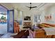 Spacious living room with a stone fireplace, tile floors, comfortable seating, and an open doorway to the patio at 13627 E Monument Dr, Scottsdale, AZ 85262