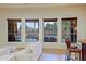 Bright living room offering views of the outdoor pool and waterfall feature through the large picture windows at 13627 E Monument Dr, Scottsdale, AZ 85262
