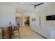 Open living room features a wet bar, tile floors, and access to other rooms at 13627 E Monument Dr, Scottsdale, AZ 85262