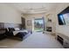 Main bedroom with ceiling fan, fireplace, and access to outdoor space, perfect for relaxation at 13627 E Monument Dr, Scottsdale, AZ 85262