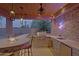 The outdoor kitchen features a grill, bar seating, a sink, and ample counter space for outdoor cooking and entertaining at 13627 E Monument Dr, Scottsdale, AZ 85262