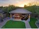 Custom outdoor kitchen features a bar, fire pit, seating, and a built-in grill at 13627 E Monument Dr, Scottsdale, AZ 85262