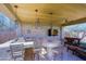 A luxurious outdoor kitchen features stone accents, a built-in grill, bar seating, and cozy lounge area at 13627 E Monument Dr, Scottsdale, AZ 85262