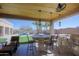 Outdoor dining area with bar seating overlooking a lavish pool and desert landscape at 13627 E Monument Dr, Scottsdale, AZ 85262
