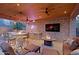 Entertain in an outdoor kitchen with bar, grill, fire pit, lounge seating, TV, and a wood ceiling under recessed lighting at 13627 E Monument Dr, Scottsdale, AZ 85262
