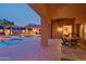 Covered patio with outdoor dining area overlooking the backyard pool, creating a perfect space for outdoor living at 13627 E Monument Dr, Scottsdale, AZ 85262