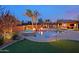 Stunning backyard with a beautiful pool, spa, outdoor kitchen, and lush landscaping, perfect for entertaining at 13627 E Monument Dr, Scottsdale, AZ 85262