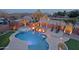 Aerial view of backyard featuring a pool, spa, waterfall, fire bowls, outdoor kitchen, lounge chairs and desert landscaping at 13627 E Monument Dr, Scottsdale, AZ 85262