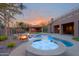 Inviting pool area with spa, rock features, and an outdoor kitchen, perfect for entertaining at 13627 E Monument Dr, Scottsdale, AZ 85262