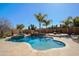 Inviting backyard pool featuring a spa, waterfall feature, and mature tropical landscaping for a resort-like feel at 13627 E Monument Dr, Scottsdale, AZ 85262
