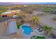 Private backyard features a custom pool, spa, covered patio, and lush desert landscaping at 13627 E Monument Dr, Scottsdale, AZ 85262