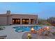 Spectacular pool and spa with rock features, fire accents, and a covered outdoor kitchen at 13627 E Monument Dr, Scottsdale, AZ 85262