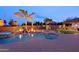 Gorgeous backyard pool area with waterfall feature, fire bowls, and lush landscaping, perfect for relaxation at 13627 E Monument Dr, Scottsdale, AZ 85262